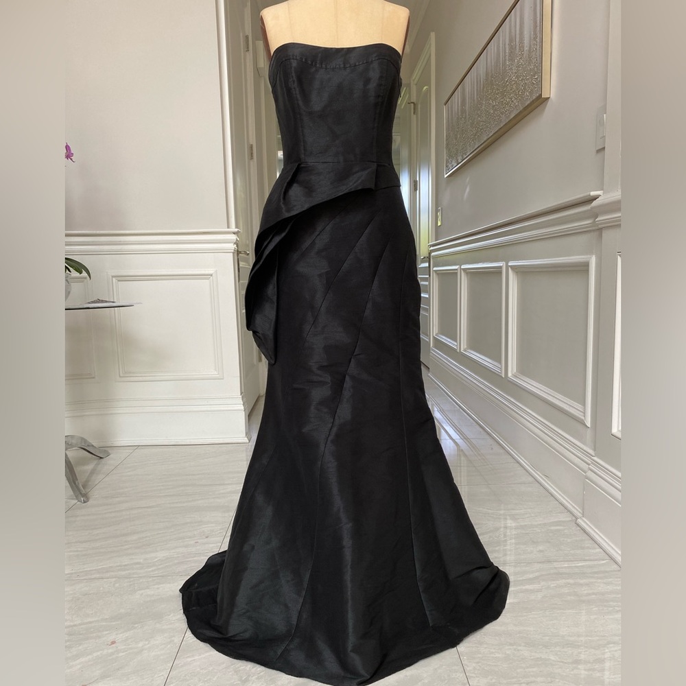 Black strapless gown with asymmetrical peplum
